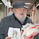 Illustration for article titled The Con Pays Off: After Years Of Feigning Interest, George R.R. Martin Has Bolted From The ‘Elden Ring’ Offices With All The Topless Elf Concept Art His Arms Can Carry